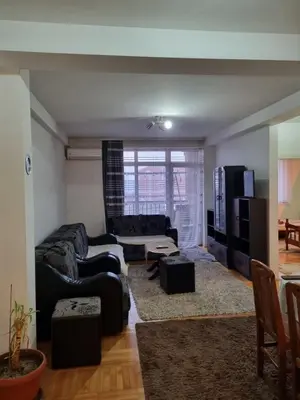 a living room with a couch and a table at Vucko Apartmani in Prokuplje