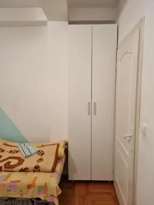 a bedroom with a bed and a closet at Vucko Apartmani in Prokuplje
