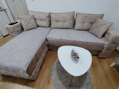 a couch with a white table in a living room at Apartman Peca in Vrnjci