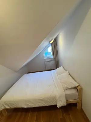 a bedroom with a white bed with a window at Eli's APARTMENT 31 in Brzeće
