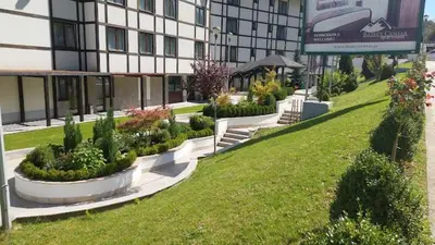 a building with a green lawn in front of a building at Eli's APARTMENT 31 in Brzeće
