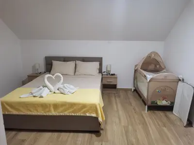 a bedroom with a bed with two towels on it at Apartmani Vila Dragana Vrnjačka Banja in Vrnjci