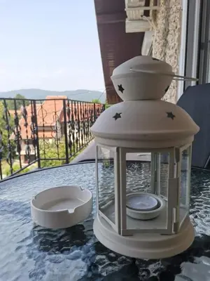 a lantern sitting on top of a table at Apartmani Vila Dragana Vrnjačka Banja in Vrnjci