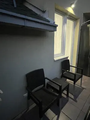 two chairs and a table in a room at Central Duplex Apartment in Zaječar