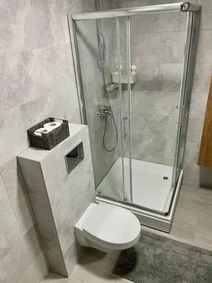 a bathroom with a shower and a white toilet at VeronaLux in Vrnjci
