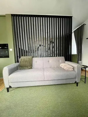 a white couch in a living room with a large window at VeronaLux in Vrnjci