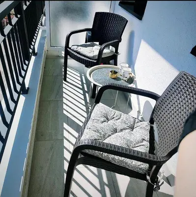 two chairs and a table on a balcony at VeronaLux in Vrnjci