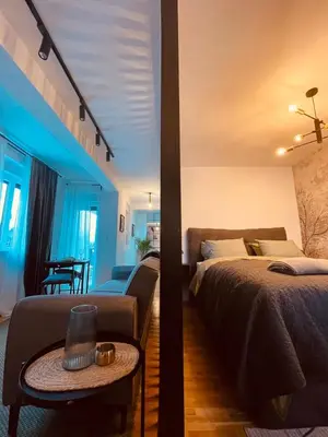 a bedroom with a bed and a living room at VeronaLux in Vrnjci