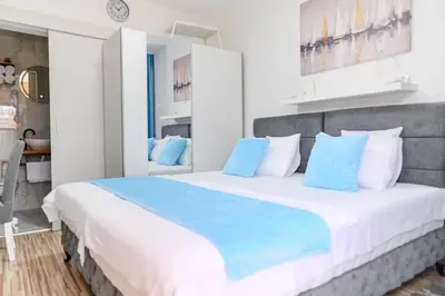 a bedroom with a large bed with blue pillows at DANESTRA Sokobanja in Soko Banja