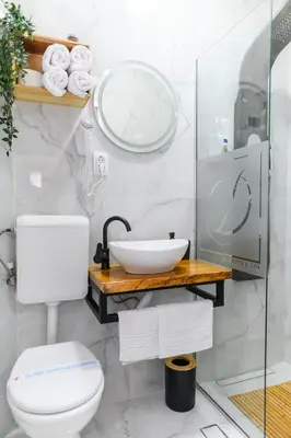 a white bathroom with a sink and a toilet at DANESTRA Sokobanja in Soko Banja