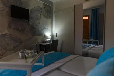 a hotel room with a bed and a tv on a wall at DANESTRA Sokobanja in Soko Banja