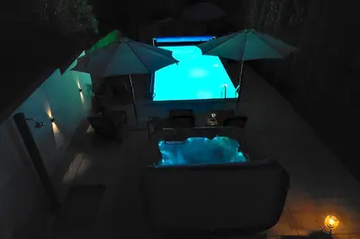 a view of a tub with umbrellas and a television at Apartmani HARMONIJA - Sokobanja in Soko Banja