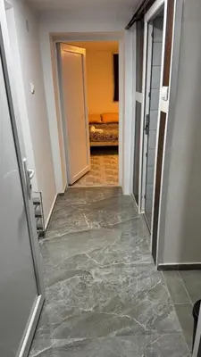 an empty hallway with a hallway leading into a room at Lucky Apartments in Leskovac