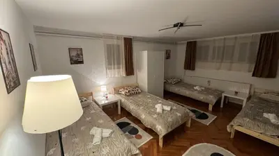 a living room with two beds and a table at Lucky Apartments in Leskovac