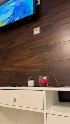 a tv sitting on top of a white dresser at Lucky Apartments in Leskovac