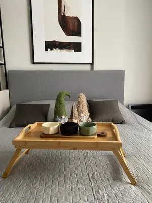 a wooden table with bowls on top of a bed at Residence Hill Chill on Kop Apartment in Kopaonik
