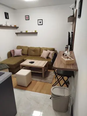 a living room with a couch and a table at Bella Winterhouse Kopaonik in Kopaonik