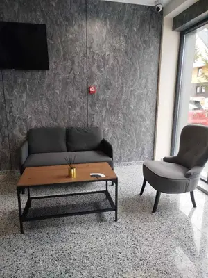 a living room with a couch and a table and a chair at Bella Winterhouse Kopaonik in Kopaonik
