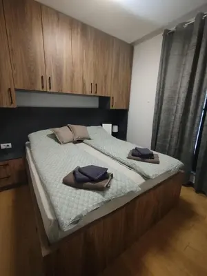 a large bed with two towels on top of it at Bella Winterhouse Kopaonik in Kopaonik