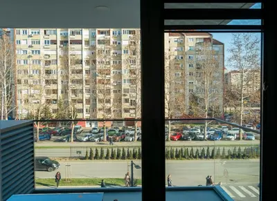 a view of a parking lot from a window at Planet Residence-Studio Solis in Niš