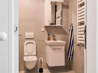 a small bathroom with a toilet and a sink at Planet Residence-Studio Solis in Niš