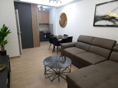 a living room with a couch and a table at ANDREAS lux apartman in Niš