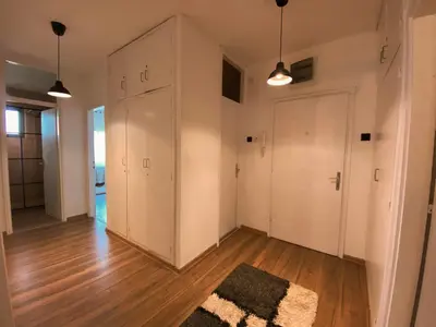 an empty room with white cabinets and a rug at Bagi Apartmani in Raška