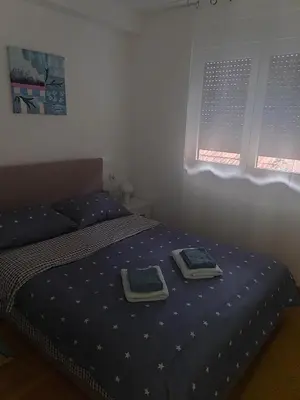 a bedroom with a bed with two plates on it at For You in Vrnjci