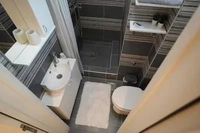 an overhead view of a bathroom with a toilet and sink at Winona apartment in Niš