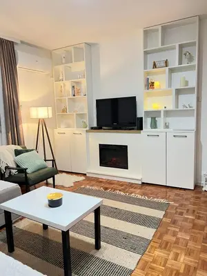 a living room with a couch and a tv at Apartman Ogledalce, 51m2, potpuno opremljeno, Kruševac Smeštaj in Kruševac