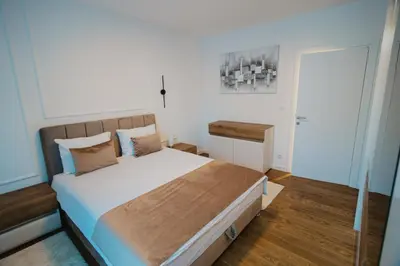 a bedroom with a large bed in a room at Residence Lux apartman & Spa in Niš