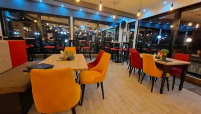 a dining room with tables and chairs in a restaurant at Gold Apartments Kopaonik in Kopaonik
