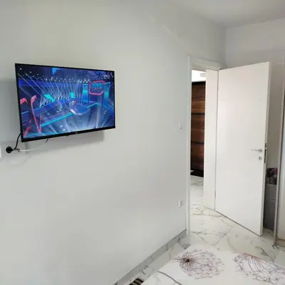 a living room with a flat screen tv on a wall at Cera maximus apartment in Soko Banja