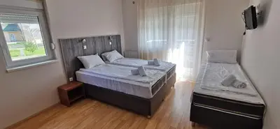 a small bedroom with a bed and a window at Villa MILSA Half Board & Pool in Soko Banja