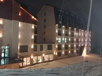 a large building with lights on it at night at Apartman Simona President Kop in Kopaonik