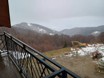 a view of a snowy mountain from a balcony at Apartman Simona President Kop in Kopaonik