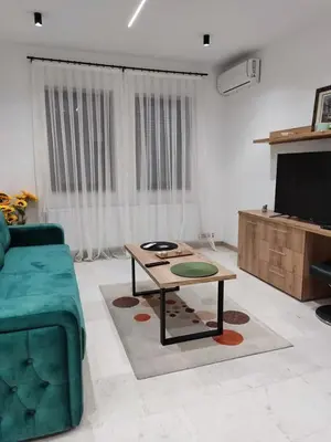 a living room with a couch and a coffee table at Apartman Novak Luxury in Aleksandrovac