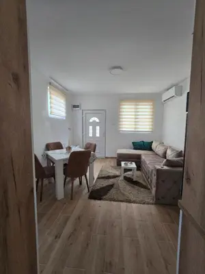 a living room with a couch and a table at Apartman Kocić in Temska