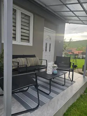 a patio with a bench and a table at Apartman Kocić in Temska
