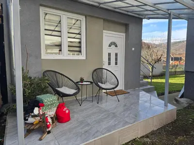 a patio with two chairs and a table at Apartman Kocić in Temska