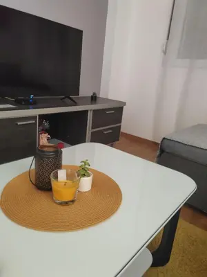 a table with a hat and a plant on it at For You Vrnjačka Banja in Vrnjci