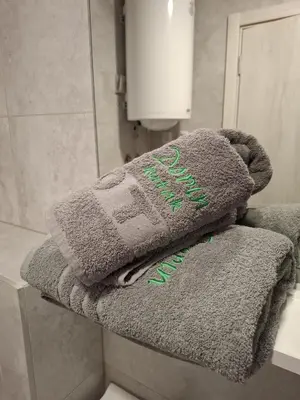 a pile of towels sitting on a counter in a bathroom at Dorin Kutak in Vrnjačka Banja