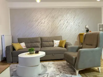 a living room with a couch and two chairs at Dorin Kutak in Vrnjačka Banja