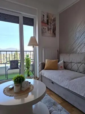 a living room with a couch and a table at Dorin Kutak in Vrnjačka Banja