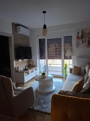 a living room with a couch and a table at Dorin Kutak in Vrnjačka Banja