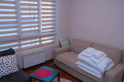 a living room with a couch and a window at Lux Studio Kraljevi Čardaci in Kopaonik