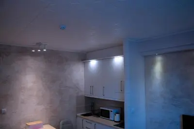a kitchen with white cabinets and a microwave at Lux Studio Kraljevi Čardaci in Kopaonik