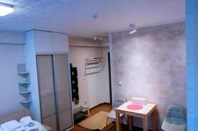 a room with a table and chairs and a wall at Lux Studio Kraljevi Čardaci in Kopaonik
