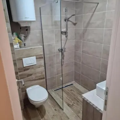 a bathroom with a shower with a toilet and a sink at Milmari Resort Spa and Wellness, Nlux 52a in Kopaonik