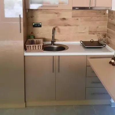 a kitchen with a sink and a counter top at Milmari Resort Spa and Wellness, Nlux 52a in Kopaonik